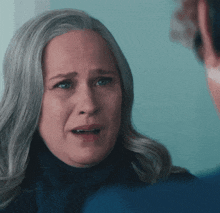 a woman with gray hair is looking at another woman