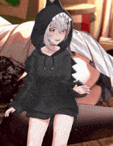 a girl wearing a black hoodie with a shark head