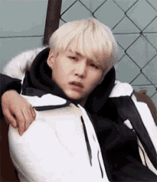 a person is putting their hand on a person 's shoulder while they are laying down .