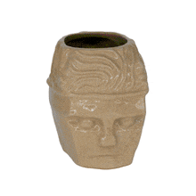 a brown mug with a handle that looks like a head