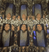 a person 's face is visible in a mirrored room