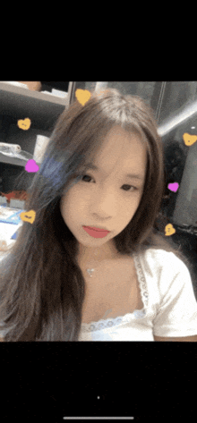 a woman with long hair is taking a selfie