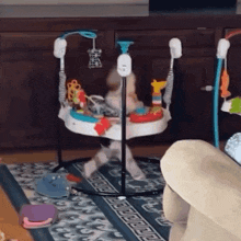 a baby is playing in an activity center in a living room .