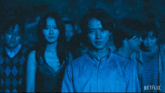 a group of people standing in a dark room with the words there 's no running from the games netflix