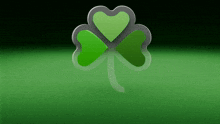 a green clover with a heart in the center