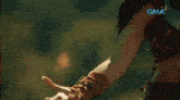a close up of a person 's arm with a gma logo in the corner