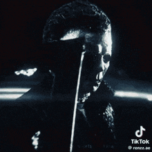 a black and white photo of a person 's face with a tiktok logo on the bottom right corner .