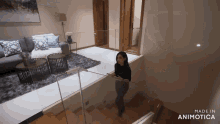 a woman is walking down a set of stairs in a living room made by animatica