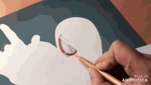 a person is drawing a face with a pencil and the words made in animatica are visible
