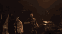 a man singing into a microphone while playing a guitar on stage
