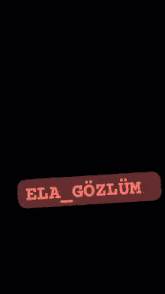 a close up of a woman 's eyes with a red sticker that says ela gozlum