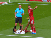 a soccer player with the number 18 on his shorts is laying on the ground