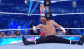 a wrestler is laying on the floor in a wrestling ring with the words #wrestlemania on the bottom