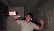 a man is playing a video game in front of a microphone .