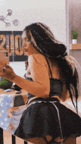 a woman is taking a selfie in a mirror with her phone .