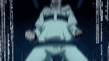 a man is sitting in a chair in a dark room with water coming out of his mouth .