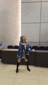 a woman in a blue kimono is dancing with a microphone