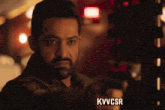 a man with a beard is pointing a gun at the camera with the words kvvcsr below him
