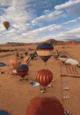 a bunch of hot air balloons are flying over the desert