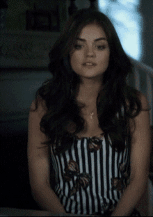 a woman wearing a black and white striped dress