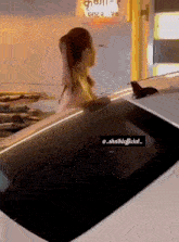 a woman is standing next to a car with a bird on the windshield .