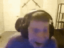 a man wearing headphones is sitting in front of a computer monitor .