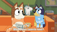 two cartoon dogs are sitting on a couch and one is reading a book and the other is asking what is their favorite food