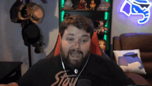 a man with a beard is wearing a black shirt that says stay