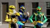 three power rangers are standing next to each other holding their swords