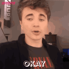 a young man wearing a nirvana shirt says " okay "