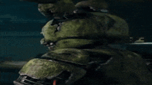 a close up of a green rabbit with a broken head