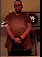 a man standing in front of a mirror with tiktok written on the bottom left