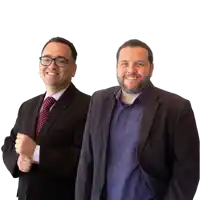 two men in suits and ties are standing next to each other and smiling