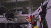 a man in a superhero costume is being attacked by another man in a superhero costume