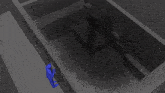 an aerial view of a dark room with a person standing in the middle