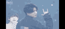 a man in a denim jacket with an american flag on the back is standing next to another man