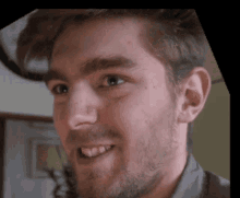 a close up of a man 's face with a beard