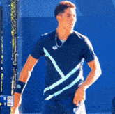 a tennis player is standing in front of a scoreboard that says 30 15
