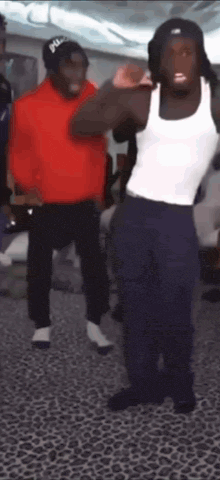 two men are dancing together in a room .
