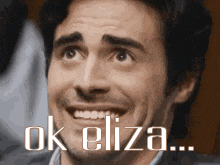 a man is making a funny face with the words ok eliza written below him