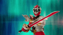 a red and white power ranger is holding two swords in his hands .