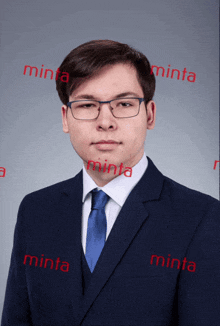 a man wearing glasses and a suit is surrounded by minta advertisements