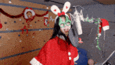 a woman in a santa suit singing into a microphone