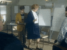 a woman stands in front of a white board that says " module 2 " on it