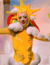 a woman in a yellow sun costume with a rainbow and clouds on her head