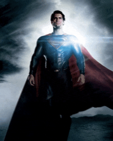 a man in a superman costume is standing in the clouds