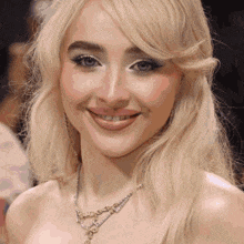 a close up of a woman 's face with a necklace on