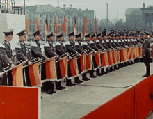 a row of men in military uniforms stand in a line