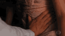 a man is touching a woman 's stomach with his hand .