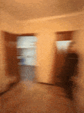a blurry picture of a room with a person walking through it